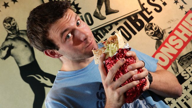 man eating big burrito